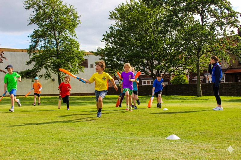 Kids having fun playing cricket at cricket camp